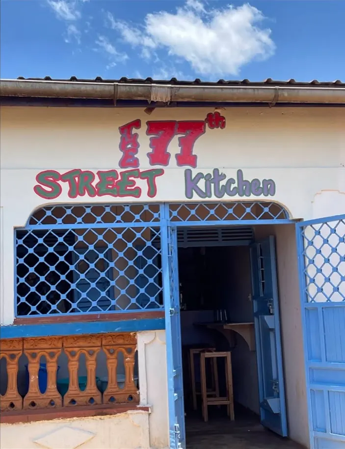 77th Street Kitchen sign and blue doors on 77 Street in Yala
